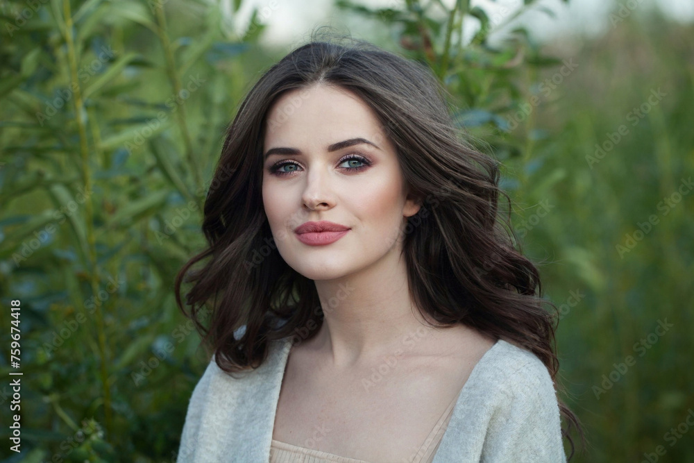 Nice female model with makeup, clean skin, healthy hairstyle and friendly smile in blossom park. Natural beauty woman portrait Nice female model with makeup, clean skin, healthy hairstyle and friendly smile in blossom park. Natural beauty woman portrait