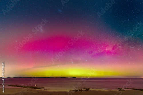 Aurora Australia illuminating the night sky over the ocean photo