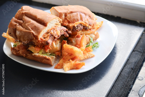 Masala steak Gatsby. South African fast food roll filled with chips, steak, braised onions and sauce. 