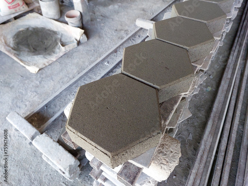 Many hexagonal cement brick flooring are stacked in construction supply stores.