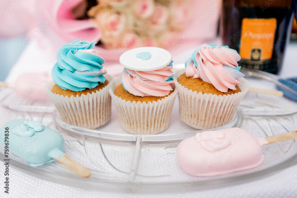 a Pastel cupcakes and popsicles on display for a celebration