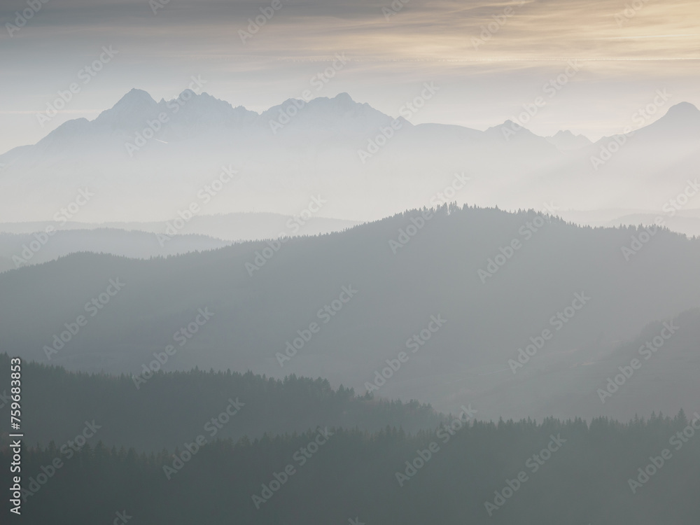 Evening landscape.. There is fog in the valley. View of the Tatra Mountains from the Pieniny Mountain Range. Slovakia.