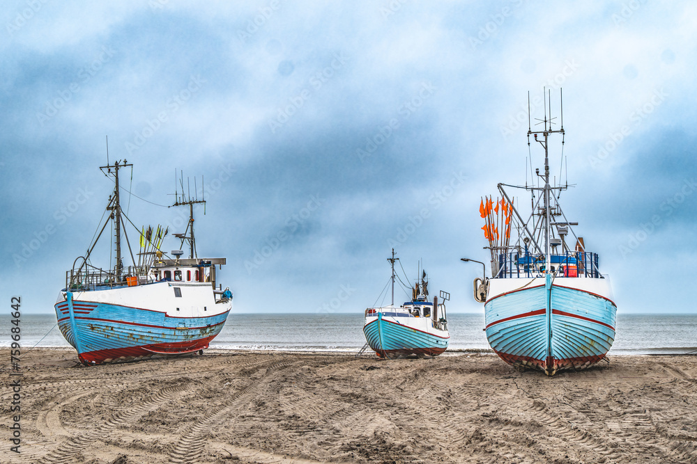 Thorup beach with active fishing vessels cutters, in Thy, Denmark Thorup beach with active fishing vessels cutters, in Thy, Denmark