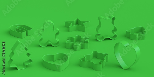 Set of metal cookie cutters for homemade Christmas biscuit on green monochrome