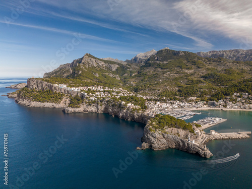Fototapeta Naklejka Na Ścianę i Meble -  The aerial view of Port de Soller, located in Mallorca, Spain, captures the picturesque harbor and the charming coastal town. 