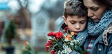 An emotive image of a mother comforting her son while holding flowers at a cemetery