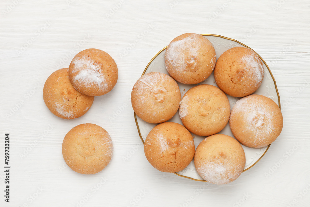 Round-shaped pastry, sprinkled with powdered sugar, on a plate. view from above Round-shaped pastry, sprinkled with powdered sugar, on a plate. view from above