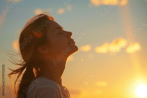 photo of woman looking up at sky with faith