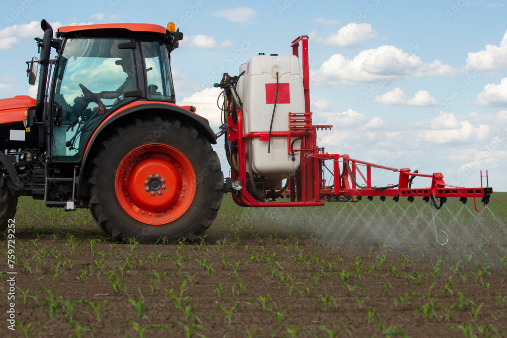 Tractor spraying pesticides at corn fields Tractor spraying pesticides at corn fields