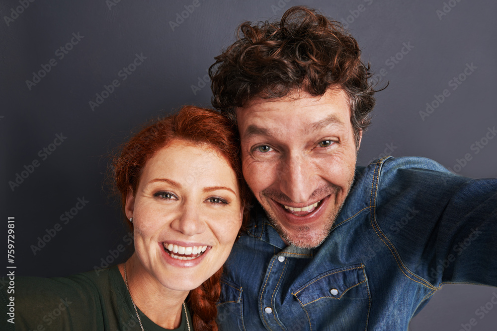 Love, selfie and happy couple in studio together with relationship trust, care and support. Photography, man and woman smile on dark background with commitment, loyalty and affection in marriage Love, selfie and happy couple in studio together with relationship trust, care and support. Photography, man and woman smile on dark background with commitment, loyalty and affection in marriage