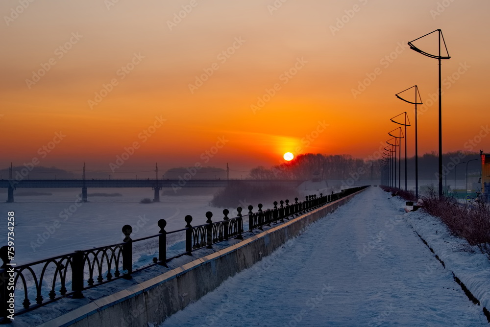 Novokuznetsk, Russia. The South of Western Siberia. The rising sun over the railway bridge on a frosty January morning.