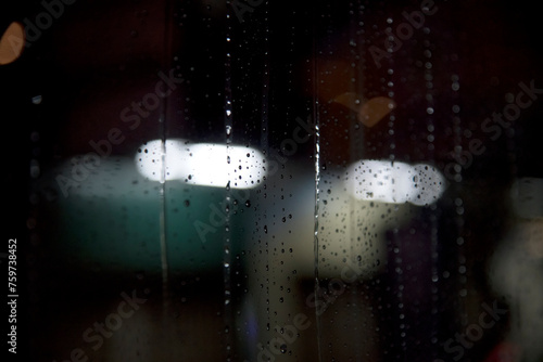 Rain drops on the bus window in the night