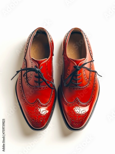 Pair of red leather brogue shoes on white background, top view. photo