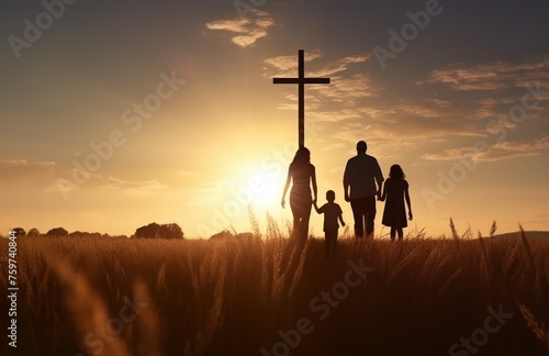 silhouette of a family walking through the field, with an empty cross in the background