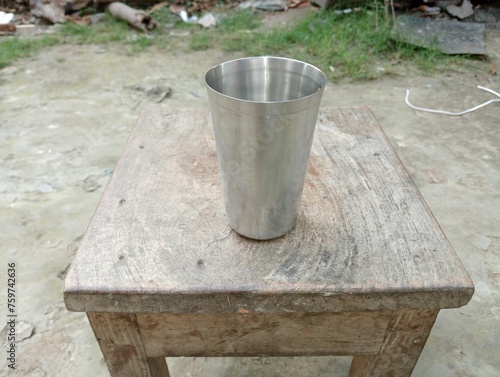 A product of steel - name mug on a wooden table.