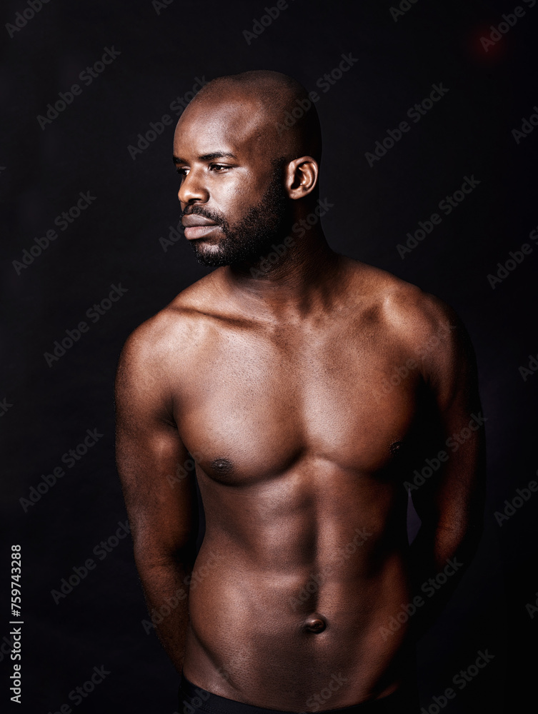Fototapeta premium Black man, shirtless and body with abs in studio, fitness and health with muscle isolated on dark background. Exercise, sport and athlete with six pack, confident and masculine with testosterone