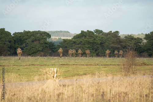 a unit of British army soldiers on a 40kg loaded march tab military exercise  Wiltshire UK