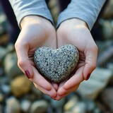 Hands Tenderly Holding a Heart-Shaped Pebble
