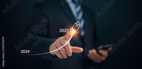 Businessman is planning for investment goals in 2025. Start new business investment and finance. Businessman points graph at 2025 target, stock market, business growth, progress or success.