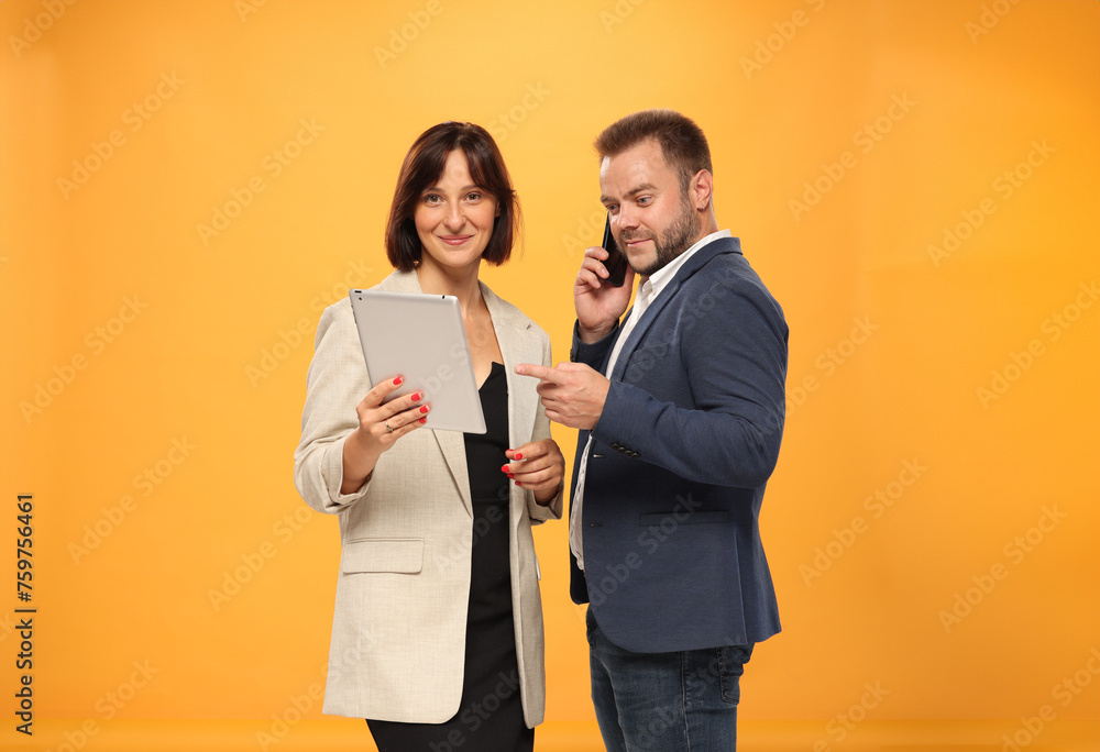 two business people approve recommend using a tablet laptop on a color background isolated two business people approve recommend using a tablet laptop on a color background isolated