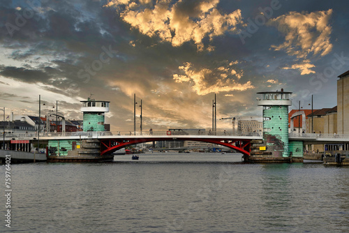 Knippelsbro, bascule bridge across the Inner Harbour of Copenhagen (Denmark) with a 
sunset dramatic sky