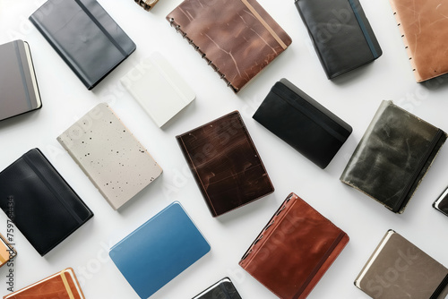 Overhead view of various wallets spread out on a white surface, showcasing different styles and textures photo