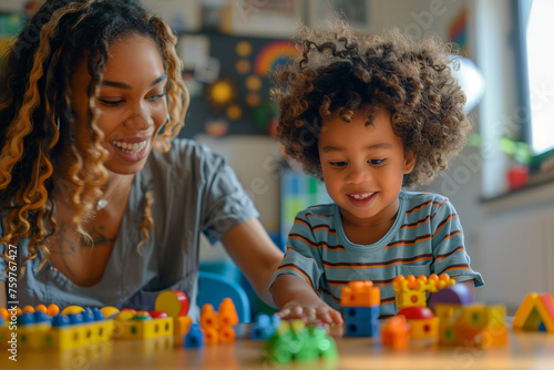 A therapist using play therapy techniques to help a child express their emotions. A black woman and a child are playing with blocks on a table