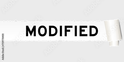 Ripped gray paper background that have word modified under torn part