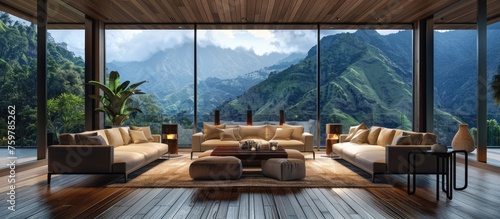 Modern meeting room interior featuring sofa, armchairs, coffee table, hardwood floors, fireplace, and panoramic tropical view. © Vusal