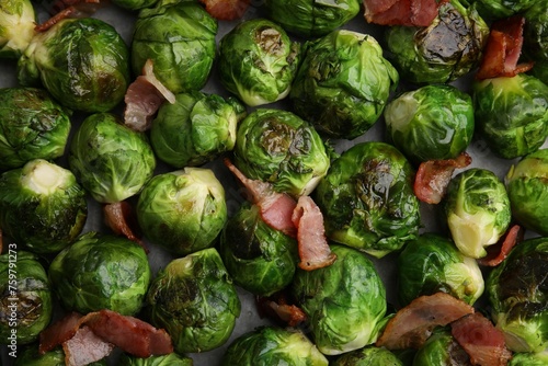 Delicious roasted Brussels sprouts and bacon as background, top view