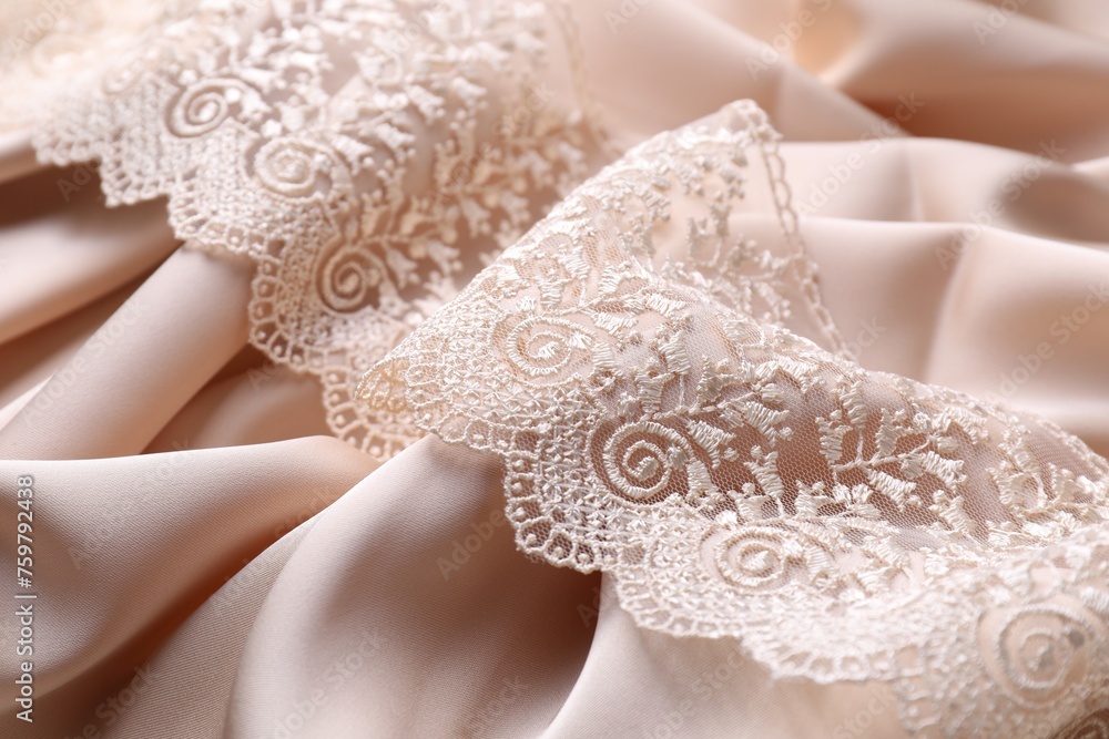 Beautiful lace on beige fabric, closeup view Beautiful lace on beige fabric, closeup view