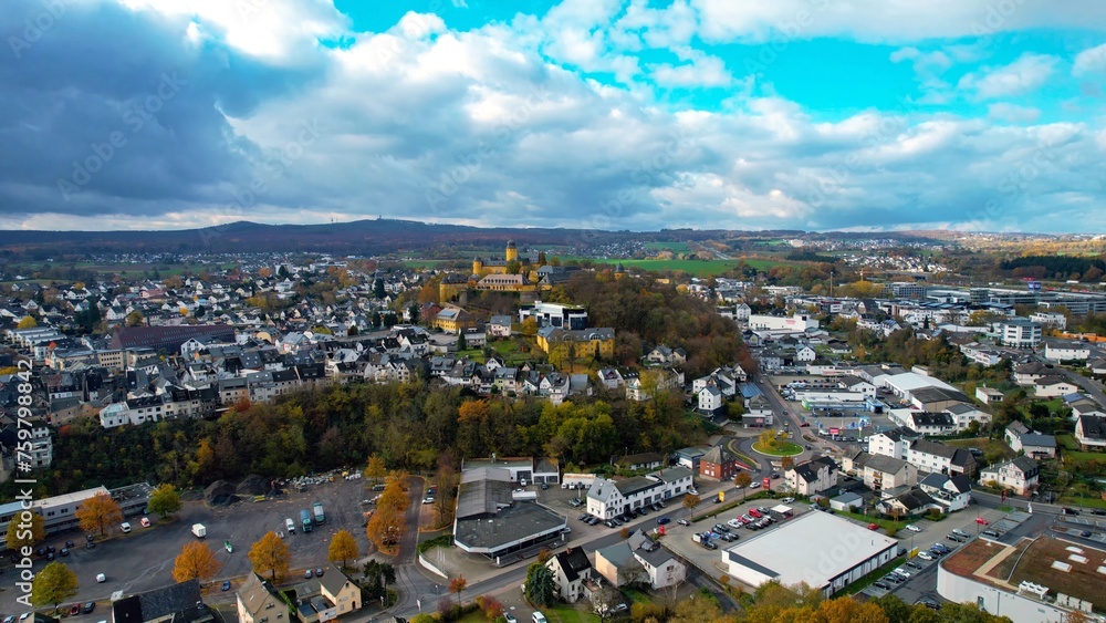  Aerial view around the old town of the city Montabauer on a cloudy day in autumn in Germany.