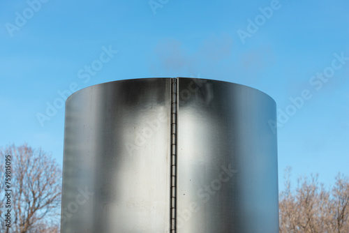 stainless steel object with hinge on a blue sky