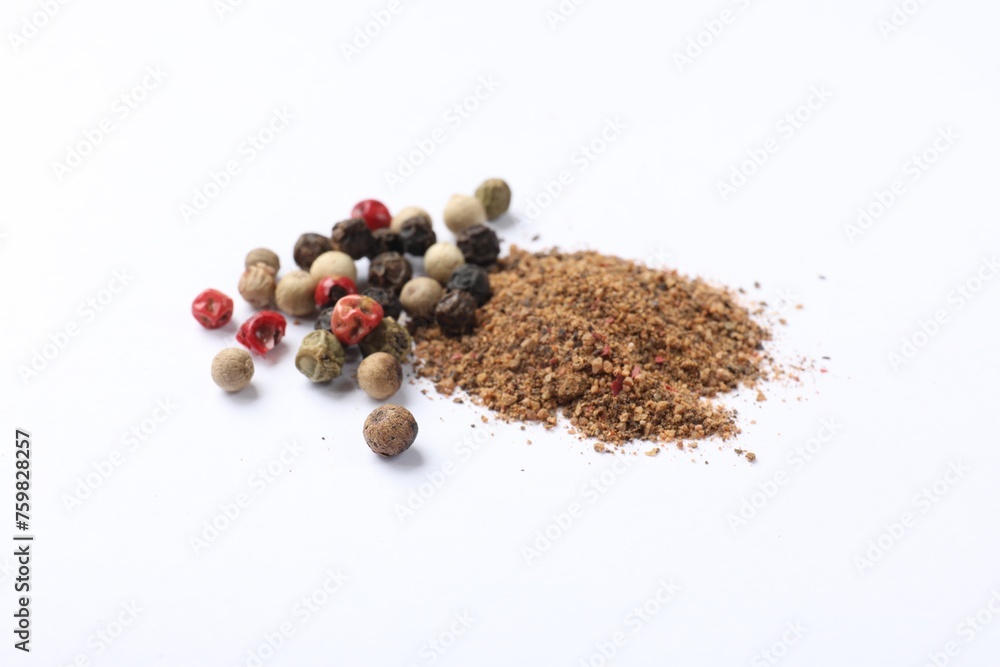 Aromatic spices. Pile of different ground and whole peppers on white background Aromatic spices. Pile of different ground and whole peppers on white background