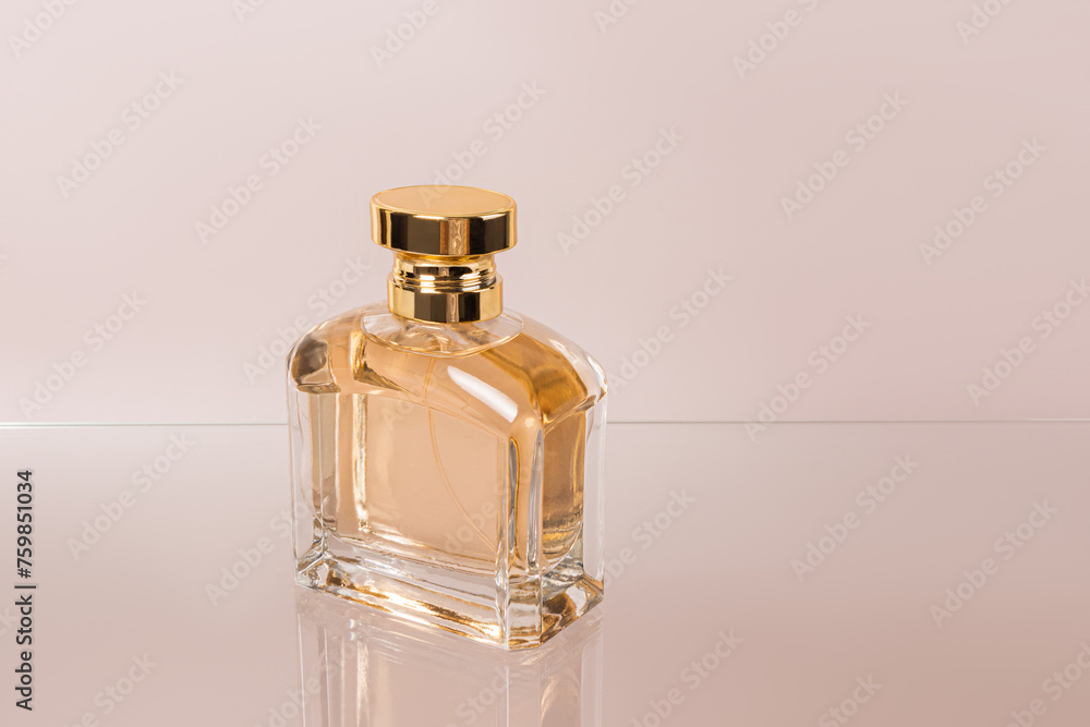 A crystal bottle of women's perfume on a glass surface. An empty presentation bottle. Advertising mockup of a bottle. Pastel background A crystal bottle of women's perfume on a glass surface. An empty presentation bottle. Advertising mockup of a bottle. Pastel background