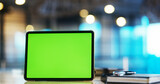 Digital tablet with green screen on the desk in the office 