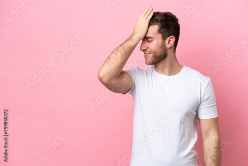 Young caucasian man isolated on pink background has realized something and intending the solution