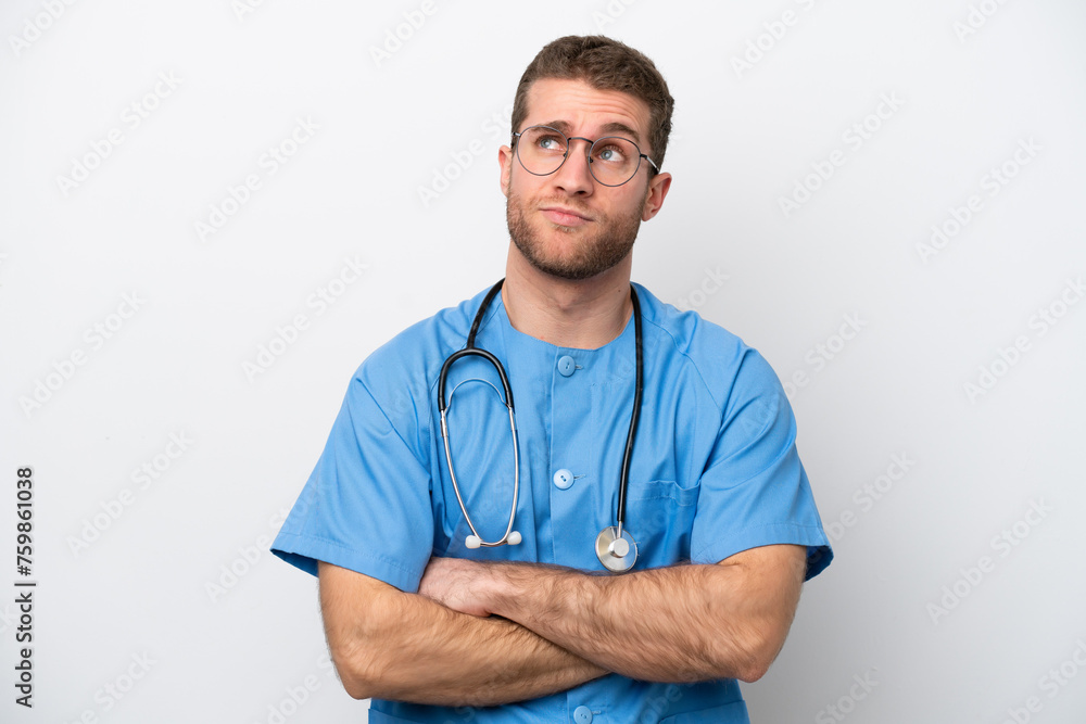 Young surgeon doctor caucasian man isolated on white background making doubts gesture while lifting the shoulders Young surgeon doctor caucasian man isolated on white background making doubts gesture while lifting the shoulders