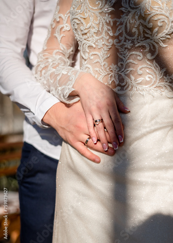 Hands of newlyweds with wedding rings	