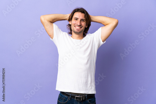 Young handsome man isolated on purple background laughing