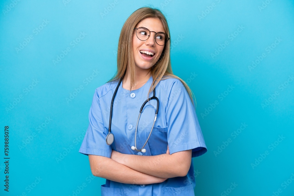 Young surgeon doctor woman isolated on blue background happy and smiling Young surgeon doctor woman isolated on blue background happy and smiling