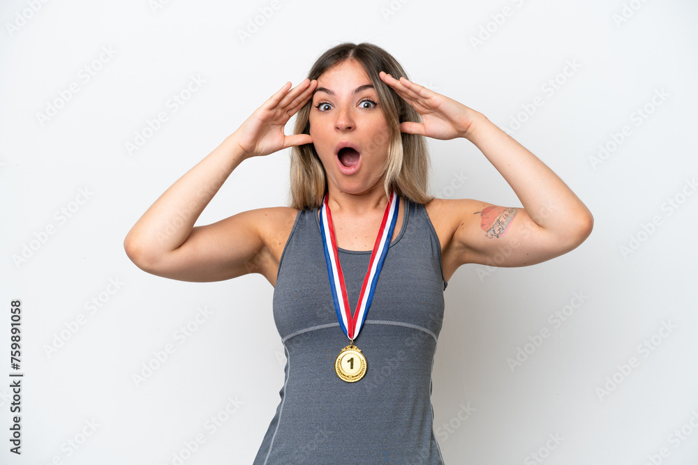 Young Rumanian woman with medals isolated on white background with surprise expression Young Rumanian woman with medals isolated on white background with surprise expression