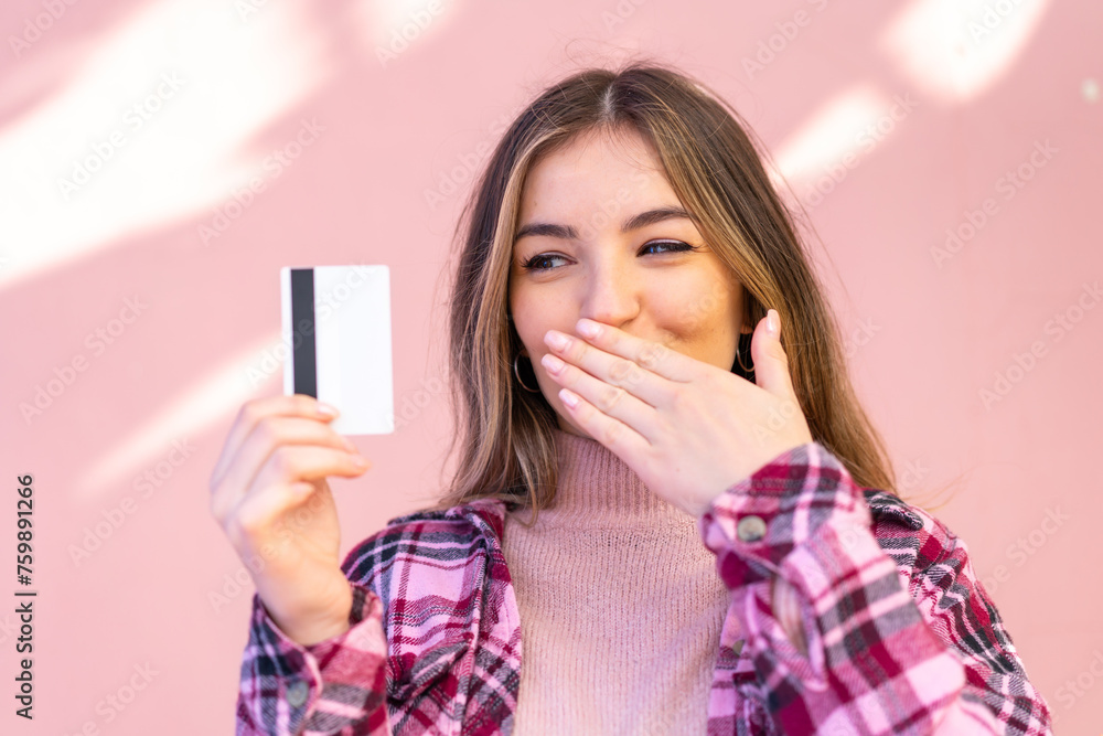 Young pretty Romanian woman holding a credit card at outdoors Young pretty Romanian woman holding a credit card at outdoors