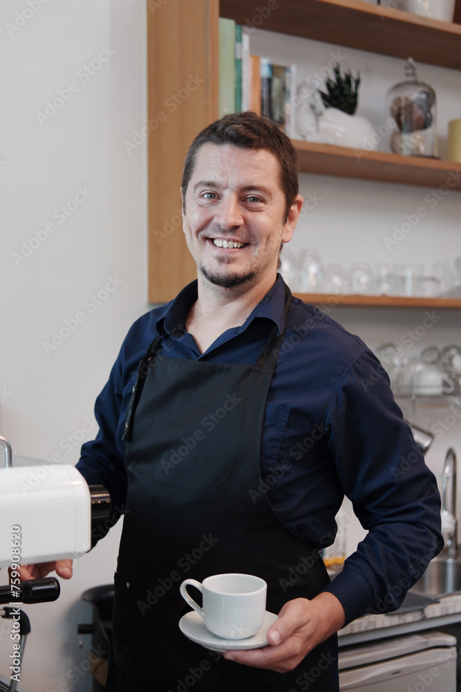 Smiling Caucasian Young barista man is wearing apron and brewing coffee with machine for customers order in cafe and coffee shop. Start up small cafe business and technology Concept Smiling Caucasian Young barista man is wearing apron and brewing coffee with machine for customers order in cafe and coffee shop. Start up small cafe business and technology Concept