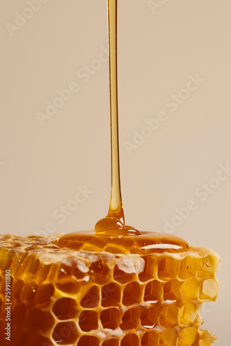 Honey Drizzling onto Fresh Honeycomb on Rustic Background