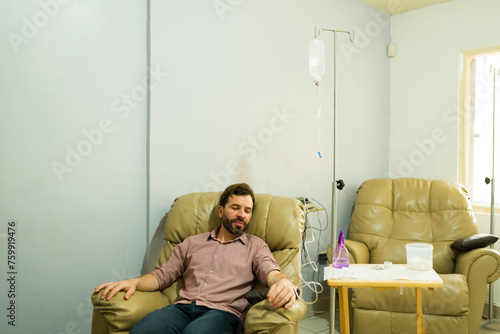 Smiling man getting a restore treatment with an IV drip therapy