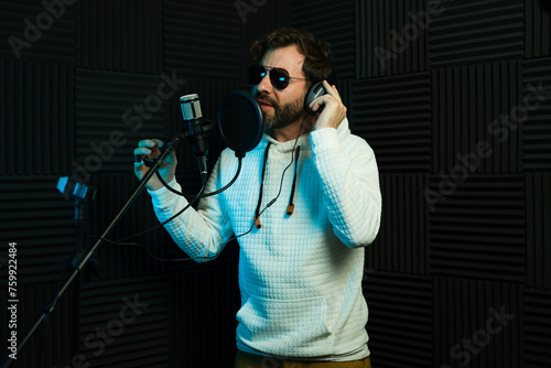 Male vocalist recording in studio