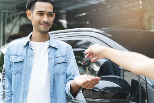 Foto Buy second-hand auto or rent a car concept, Close-up hand of used car agent giving an auto key to client