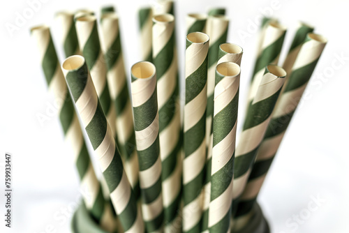 Close-up view of green and white striped paper straws in a holder photo