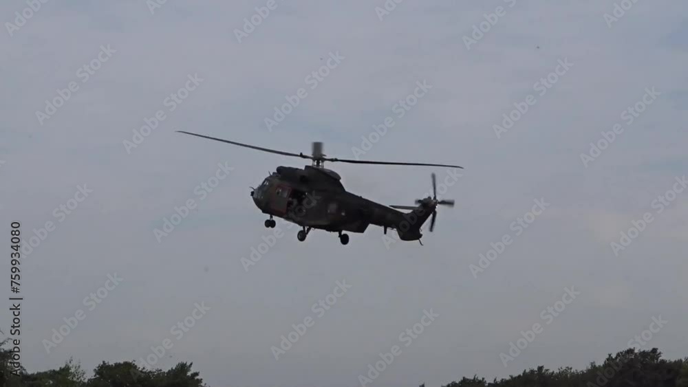Military Helicopter Landing behind the trees Military Helicopter Landing behind the trees